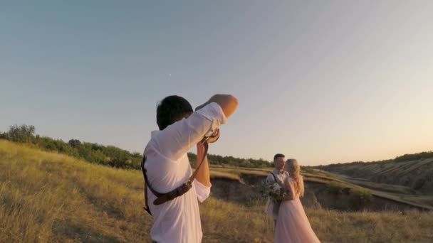 Bruiloft fotograaf neemt foto's van de bruid en bruidegom — Stockvideo