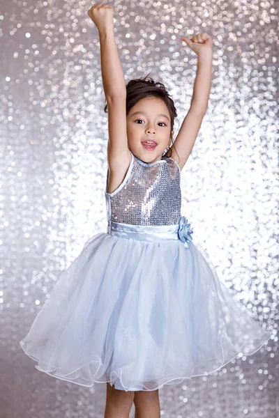 Cute smiling little child girl in silver and blue dress — Stock Photo, Image