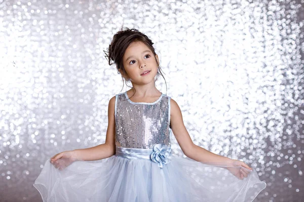 Cute smiling little child girl in silver and blue dress — Stock Photo, Image