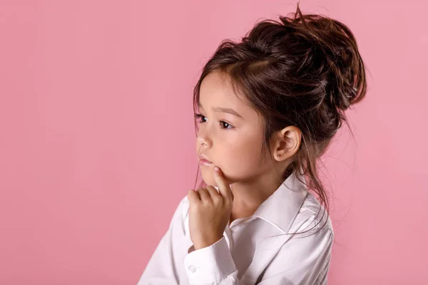Beautiful doubtful, thoughtful little girl in white shirt with hairstyle — Stock Photo, Image