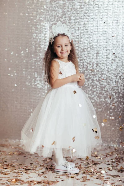 Little child girl in princess dress on confetti background — Stock Photo, Image