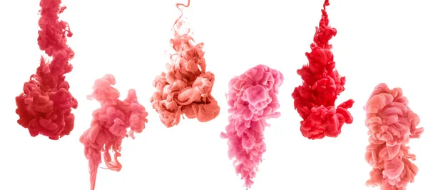 Uppsättning färgglada bläck isolerad på vit bakgrund. röd, rosa, korall droppe virvlande under vatten. — Stockfoto