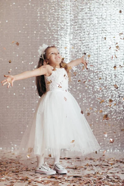 Little child girl in princess dress on confetti background — Stock Photo, Image