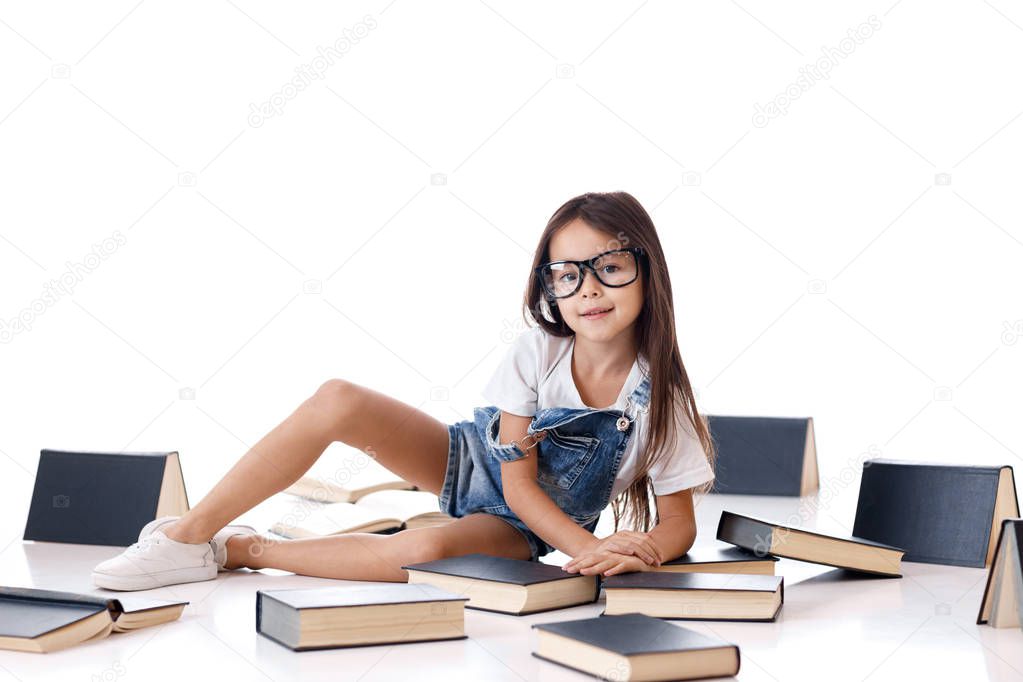 cute little girl is reading a book.