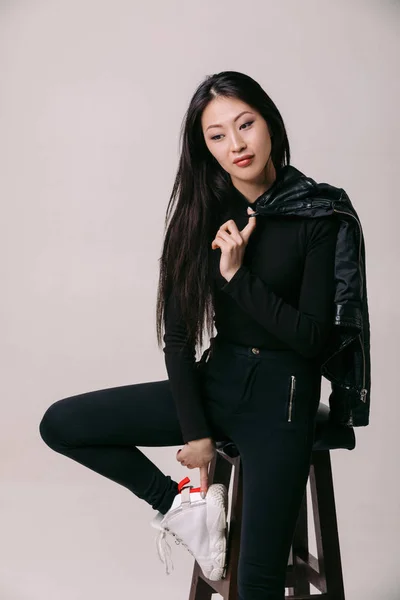 Asian model in black jacket posing in studio — Stock Photo, Image