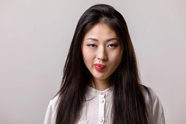 Portrait of sad asian woman in glasses and white shirt — Stock Photo, Image