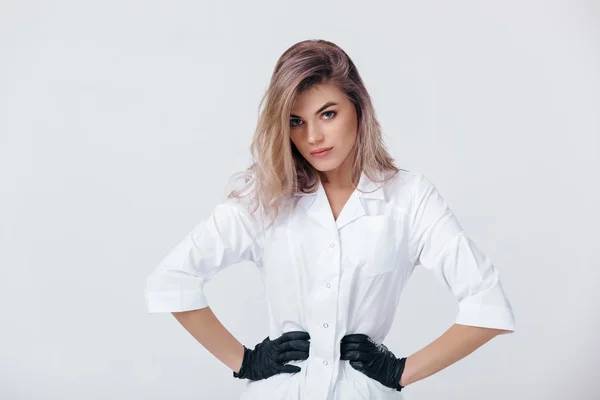 Young female professional cosmetologist in black gloves. — Stock Photo, Image