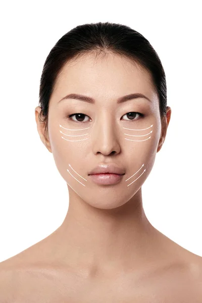 Spa portrait of attractive asian woman with arrows on her face — Stock Photo, Image