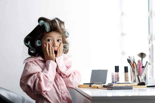 Cute little girl playing with her mothers cosmetic — Stock Photo, Image