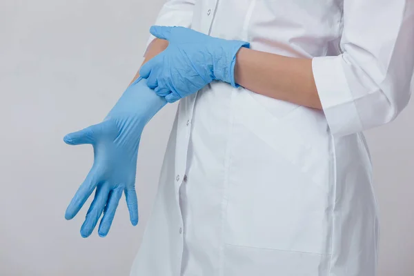 Kvinna läkare händerna i medicinsk latex blå handskar — Stockfoto