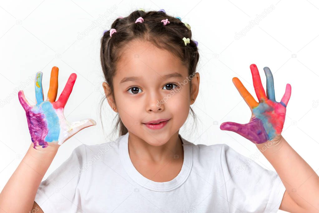 little child girl with hands painted in colorful paint