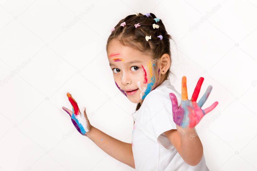 little child girl with hands painted in colorful paint