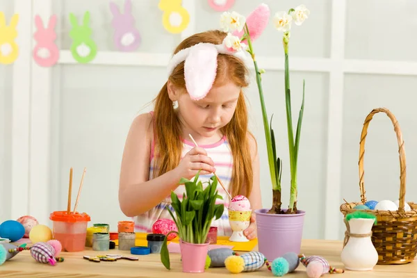 Bambina bambina con le orecchie di coniglio di Pasqua pittura uova di Pasqua — Foto Stock
