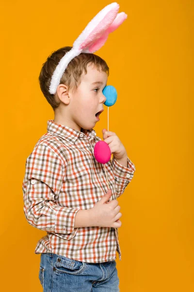Mały chłopiec dziecko z Easter bunny uszy gospodarstwa kolorowych jaj — Zdjęcie stockowe