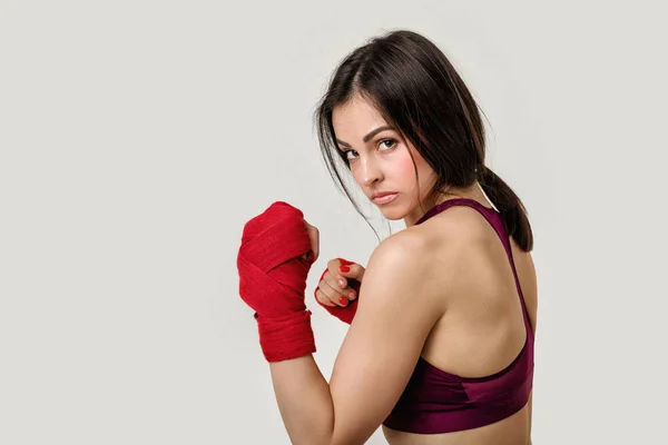 Beautiful woman boxer with red strap on wrist. — Stock Photo, Image