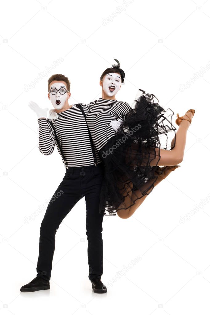 Smiling mimes in striped shirts.