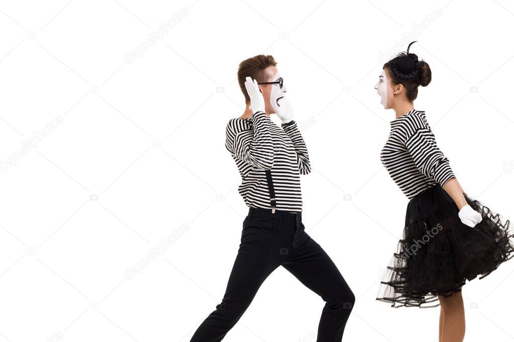 Smiling mimes in striped shirts.