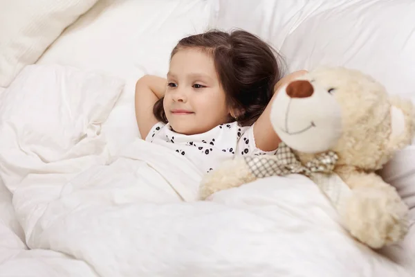 Cute little child girl wakes up from sleep — Stock Photo, Image