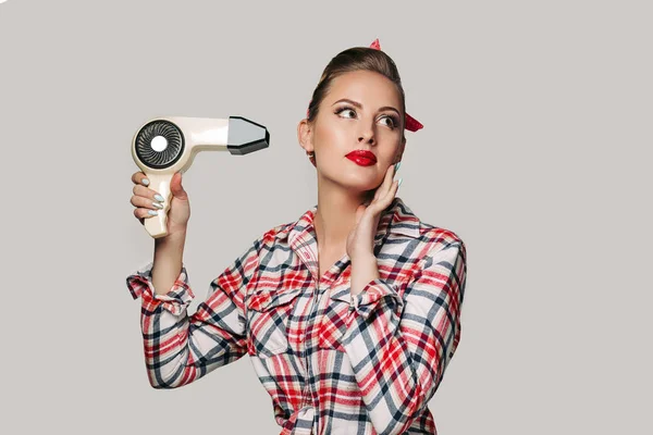 Happy young brunette woman with hair dryer. — Stock Photo, Image