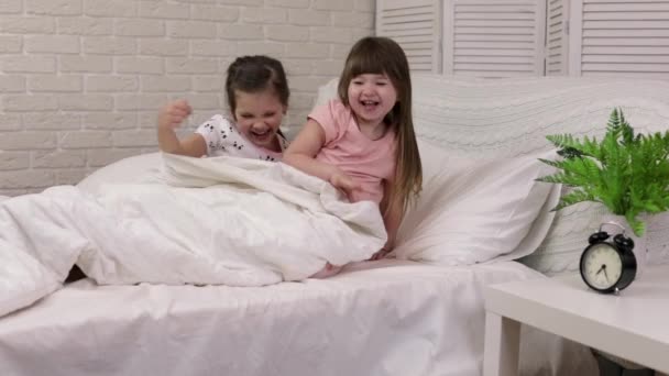 Cute little child girl wakes up from sleep in bed — Stock Video