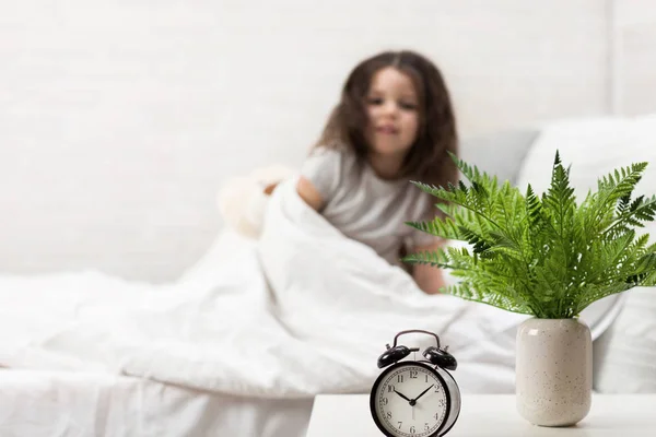 little child girl wakes up from sleep.