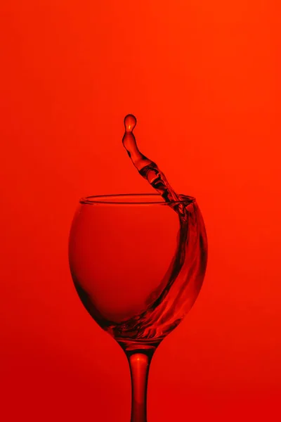 Splash of water in wineglass — стоковое фото