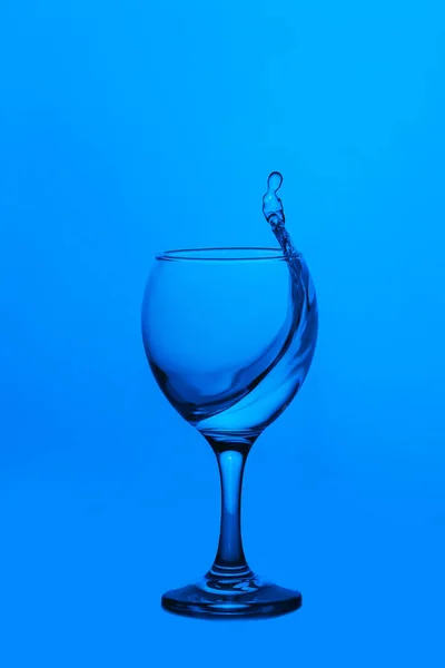 Splash of water in wineglass — Stock Photo, Image