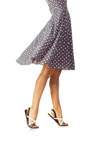 Woman in polka-dot dress standing in shoes — Stock Photo, Image