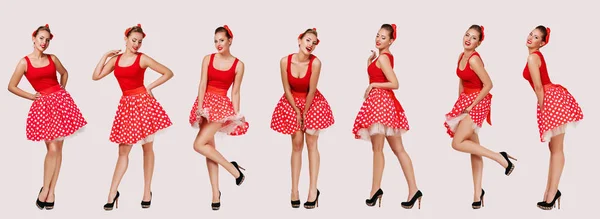 Glimlachend pin up vrouw in polka dot rode jurk — Stockfoto