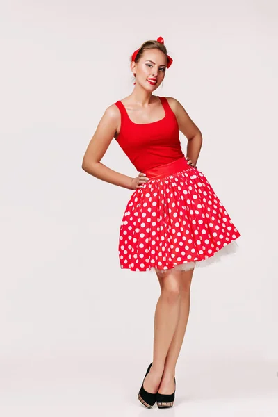 Smiling pin up woman in polka dot red dress — Stock Photo, Image