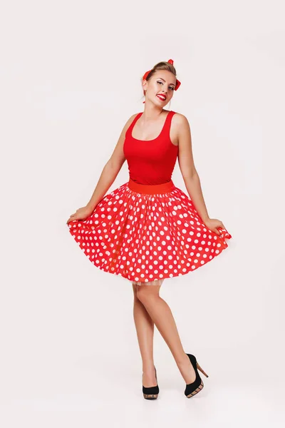 Smiling pin up woman in polka dot red dress — Stock Photo, Image