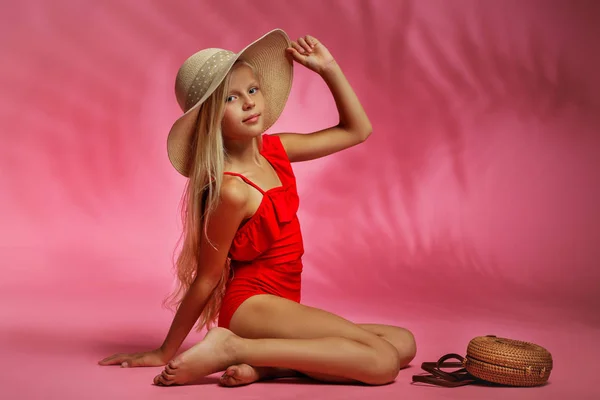 Süßes kleines Mädchen im roten Badeanzug posiert — Stockfoto