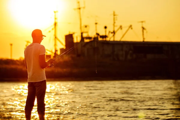 Young man fishing at sea — Stock Photo, Image