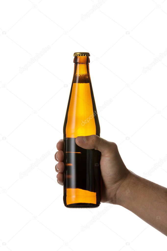 male hand holding brown beer bottle