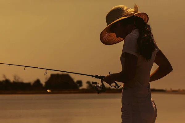 Young woman fishing at sea — Stock Photo, Image