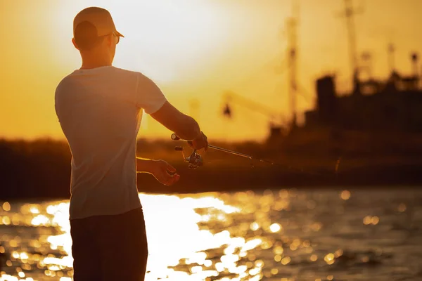 Young man fishing at sea — Stock Photo, Image