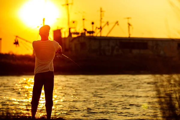 Young man fishing at sea — Stock Photo, Image