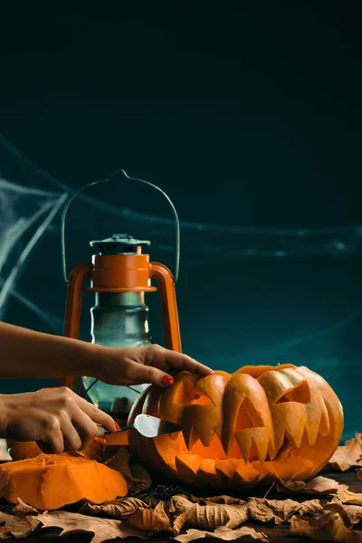 Woman prepares for halloween and carving a pumpkin — Stock Photo, Image