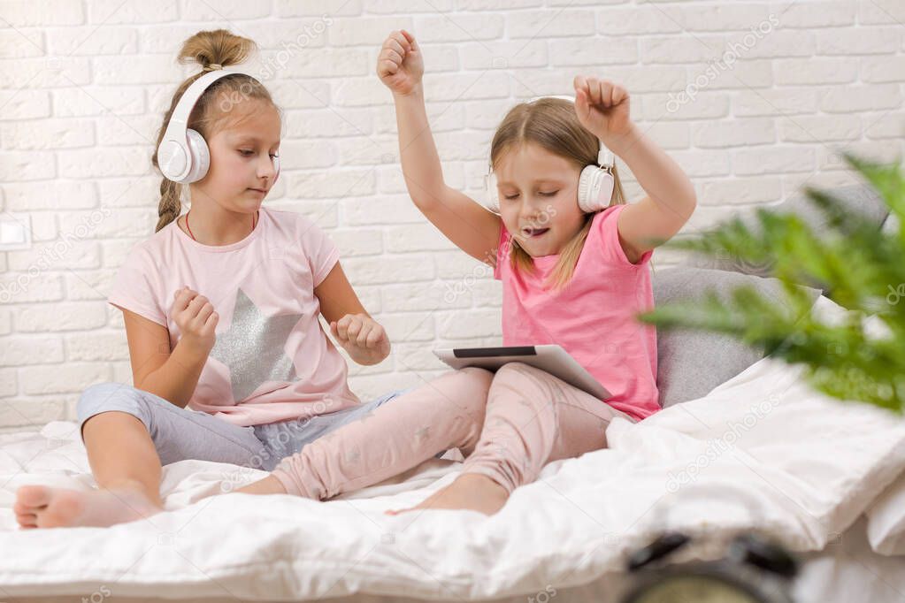 two little kids girls play in the bedroom