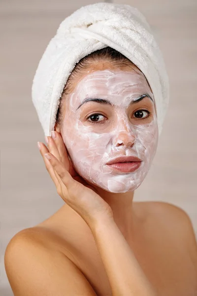 Woman is applying mask on her face — Stock Photo, Image