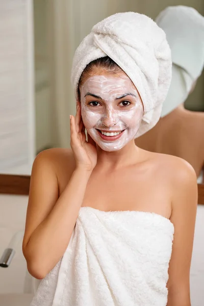 Woman is applying mask on her face — Stock Photo, Image