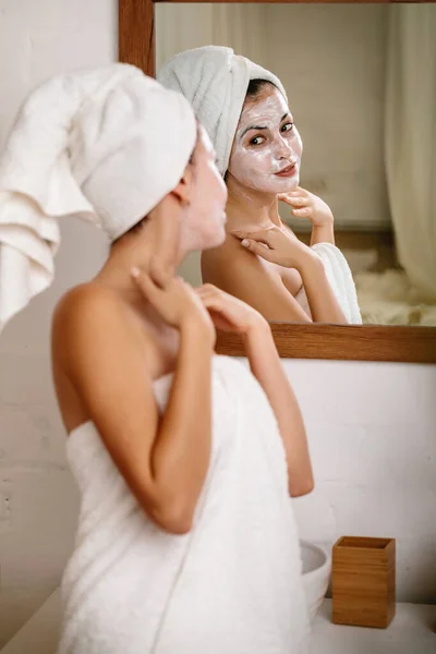 Woman is applying mask on her face — Stock Photo, Image