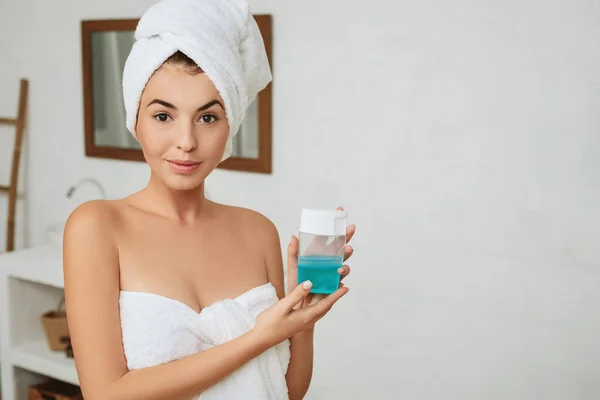 girl holding skincare product