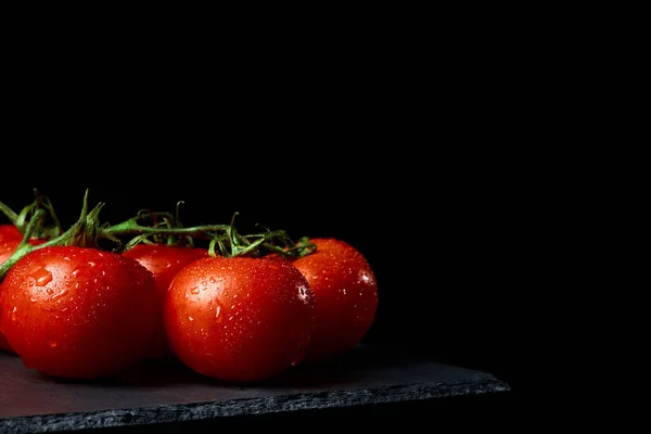 Fresh ripe red tomatoes on black background — Stock Photo, Image