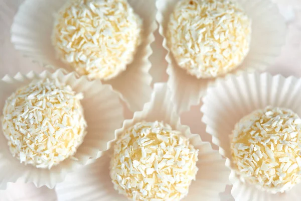 Candies covered by shredded coconut.