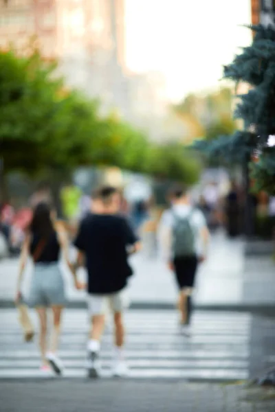 blurred people crossing street