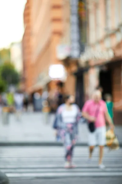 blurred people crossing street