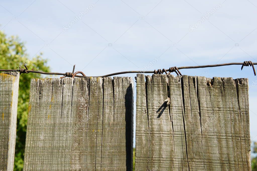 Fence wooden with barbed wire.