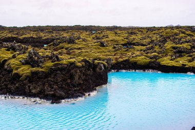 İzlanda 'daki Mavi Göl' ün yanında güzel ve karlı bir dağın fotoğrafı.