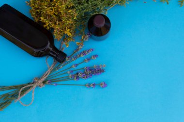 Masanın üzerinde lavanta, şişe ve bir buket çiçek var..